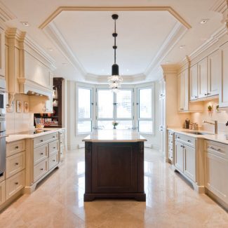 White Kitchen with a classic style with a central island and white work surface.
