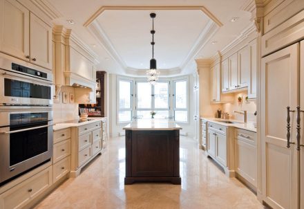 White Kitchen with a classic style with a central island and white work surface.