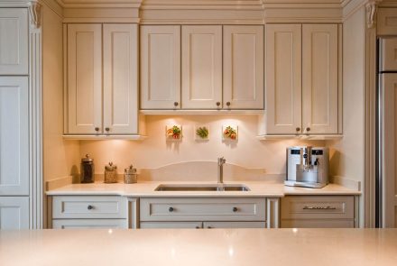 Modern white kitchen furniture with wall storage.