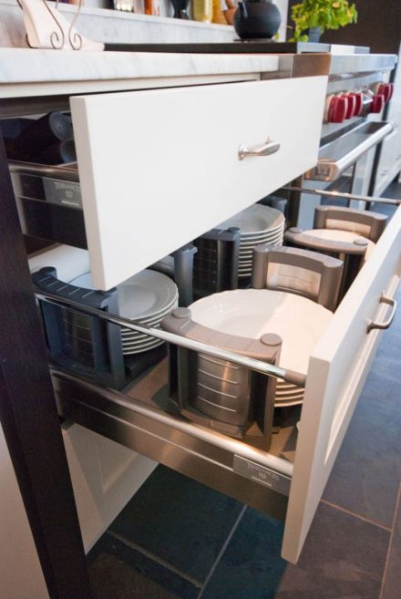 Rustic kitchen cabinet with white doors and functional storage.