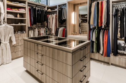 Layout of spacious closet with shelves and clothing rods.