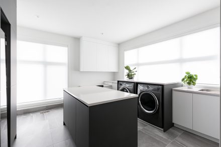 Modern sleek laundry room with central island.