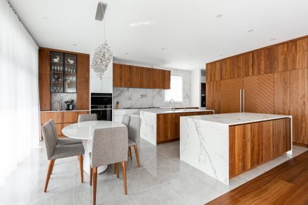 Wooden kitchen furniture with integrated refrigerator.