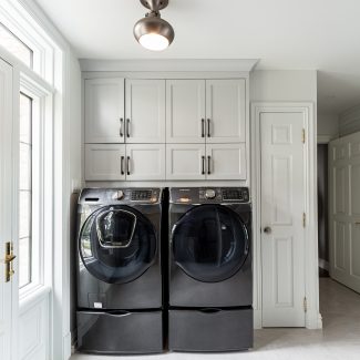 Custom white laundry room cabinets.