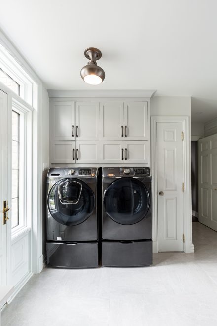 Custom white laundry room cabinets.