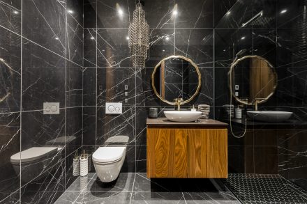 Salle de bain foncée avec rangement élégant.