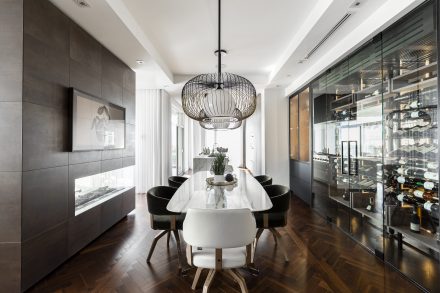 Modern Kitchen with a central island and white cabinets in a large open-concept room.