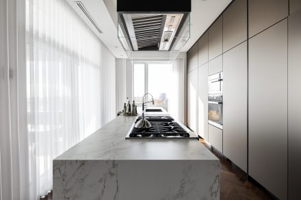 High-end Kitchen with island and light-colored cabinets.