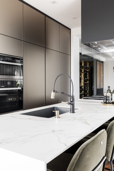 Fitted kitchen with built-in sink and dark cabinets.