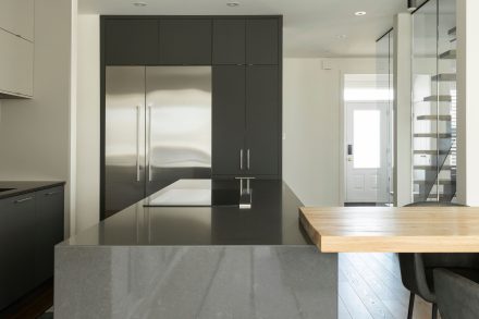 Modern kitchen with island and open shelving in a contemporary home.