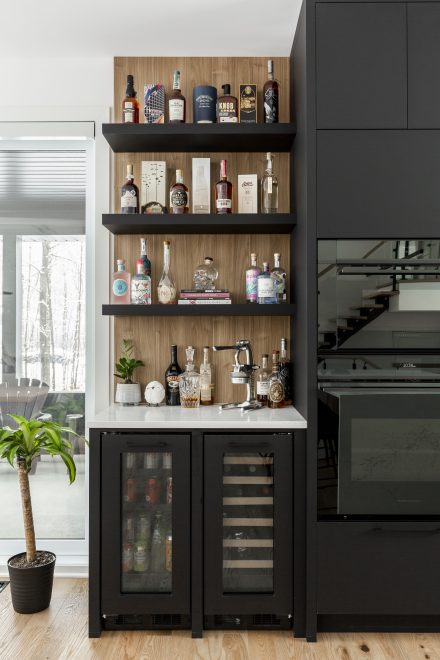 A modern kitchen with a bar area for preparing drinks.