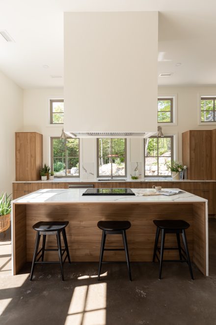 Contemporary kitchen with bright wood colored cabinets and light worktop.
