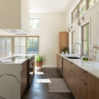 Elegant kitchen storage unit with warm and bright lighting.