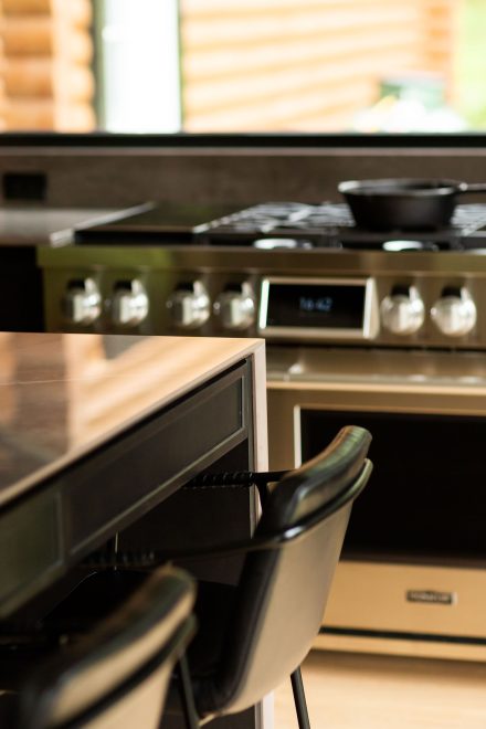 Modern kitchen furniture with dark worktops and sleek black doors Ateliers Jacob.