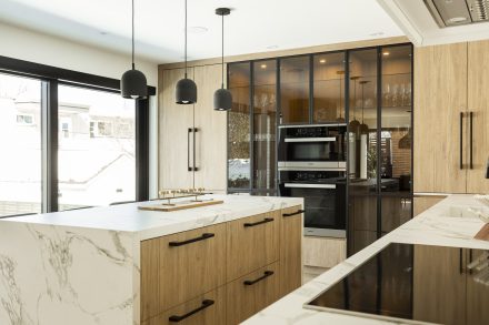Modern kitchen with contrasting countertops and central island.