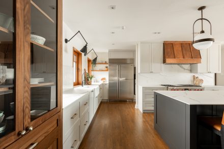 Airy white kitchen with a substantial island and multiple integrated storage solutions.