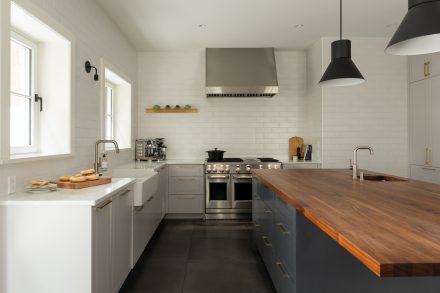 Interior of a modern fitted kitchen with soft lighting.