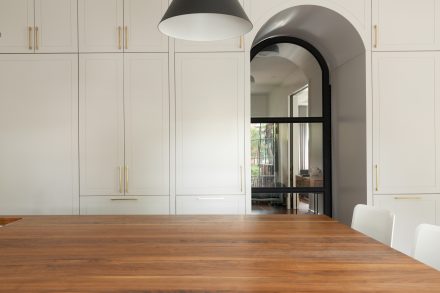 Contemporary interior with kitchen island and built-in cabinets.