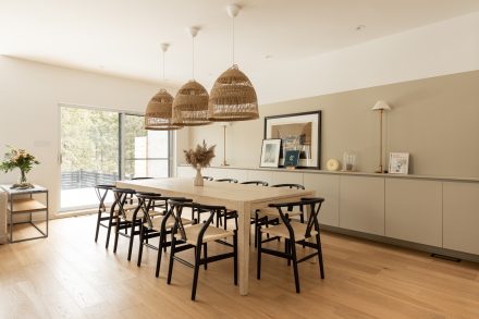 Bright dining room with integrated storage along the length of the wall.