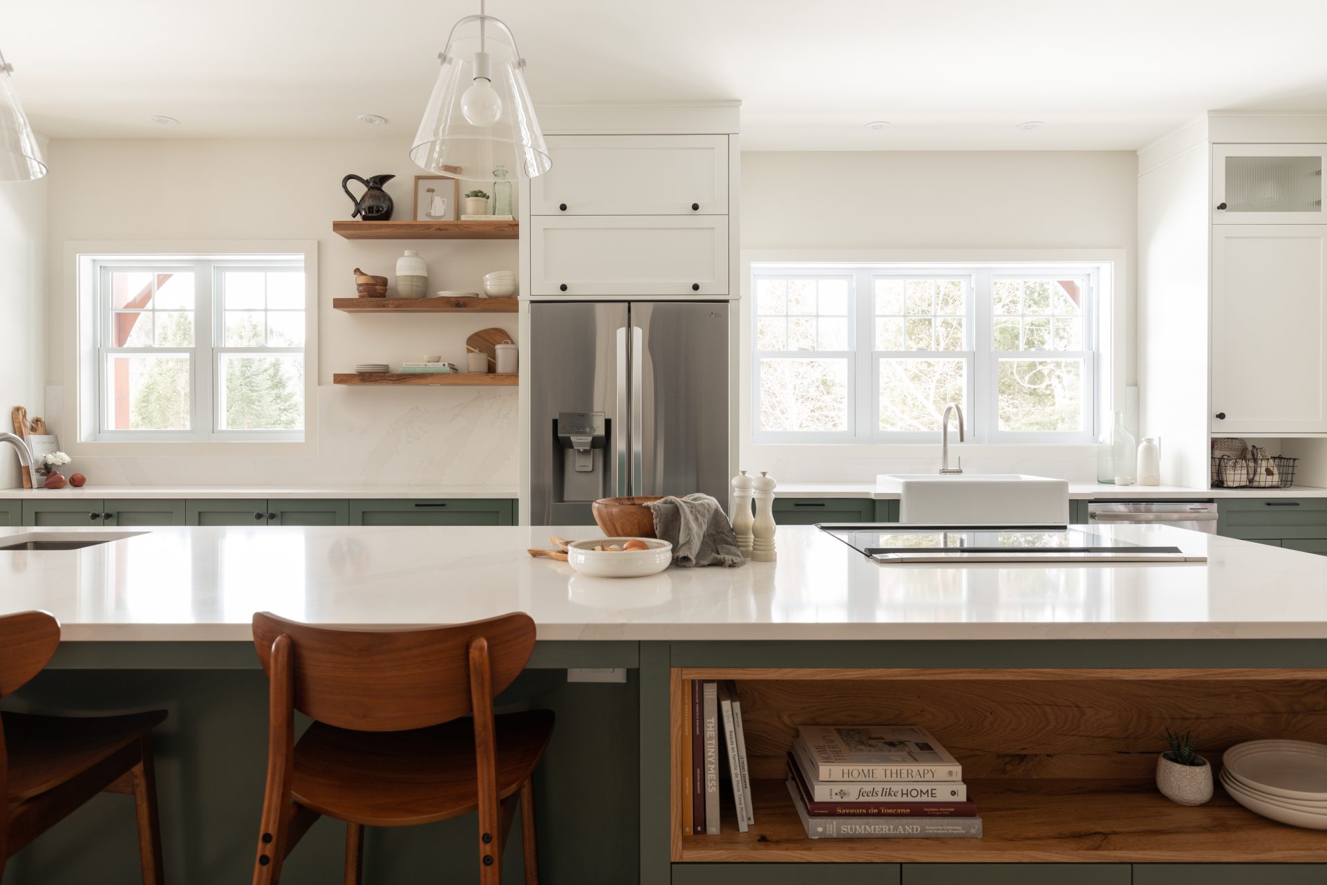 White kitchen with a lot of storage space green cabinets
