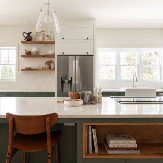 White kitchen with a lot of storage space green cabinets