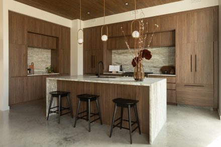 Kitchen designed by Ateliers Jacob with custom cabinets in wood and a kitchen island