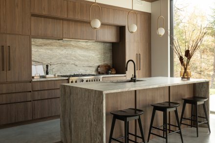 Kitchen designed by Ateliers Jacob with custom cabinets in wood and a kitchen island