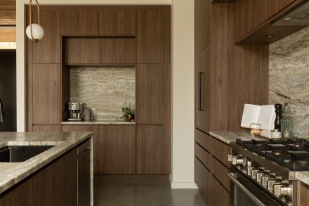 Kitchen designed by Ateliers Jacob with custom cabinets in wood and a kitchen island