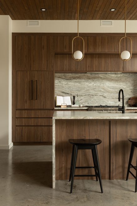 Kitchen designed by Ateliers Jacob with custom cabinets in wood and a kitchen island