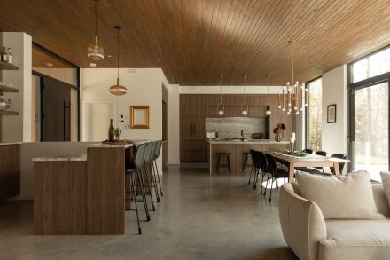 Kitchen designed by Ateliers Jacob with custom cabinets in wood and a kitchen island