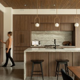 Kitchen designed by Ateliers Jacob with custom cabinets in wood and a kitchen island