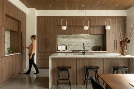 Kitchen designed by Ateliers Jacob with custom cabinets in wood and a kitchen island