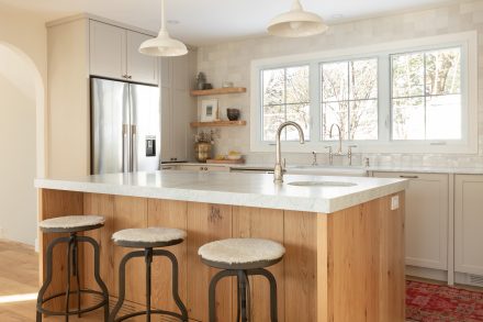 California inspired kitchen design made by Ateliers Jacob with a kitchen island, floating shelves in oak. 