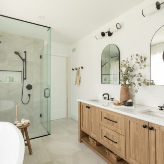 Bathroom with a bath, shower and wooden vanity in neutral tones