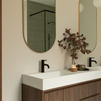 Custom made vanity with dark wood, floating shelf and arched mirors