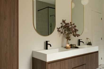 Custom made vanity with dark wood, floating shelf and arched mirors