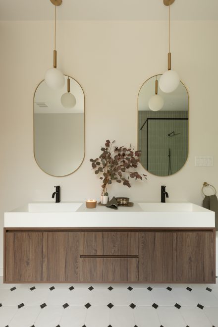 Custom made vanity with dark wood, floating shelf and arched mirors